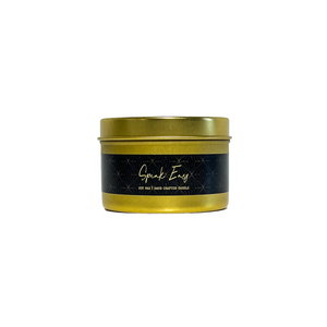 Gold, four ounce, tobacco and vanilla scented soy wax candle with a gold lid and a black label that reads Speak Easy