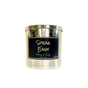 Gold, sixty four ounce, tobacco and vanilla scented soy wax candle with a gold lid and a black label that reads Speak Easy