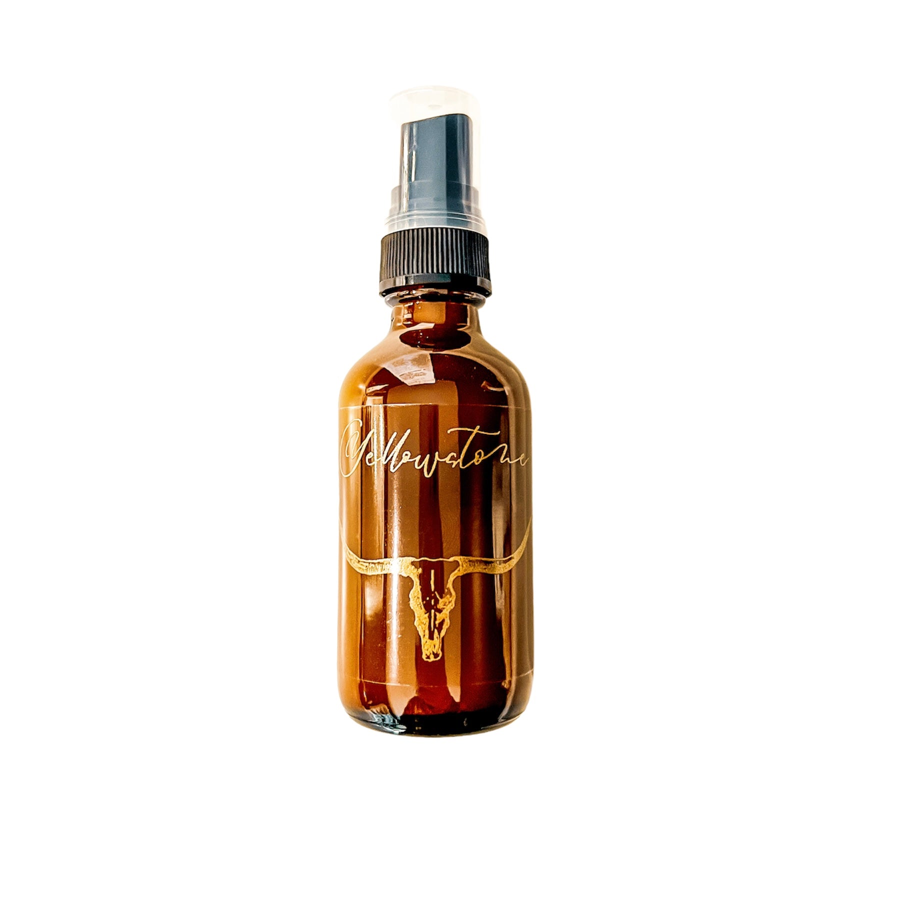Amber, two fluid ounce, leather and bergamot scented fragrance spray labeled Yellowstone in gold letters